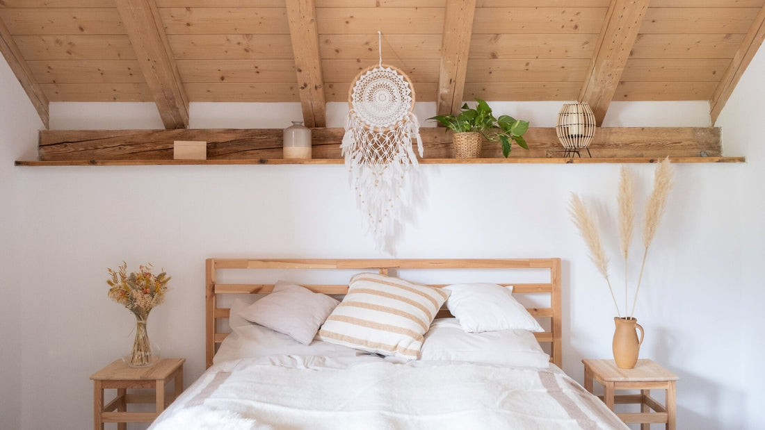 Ein großer Makramee Traumfänger hängt in einem Schlafzimmer im Boho-Stil